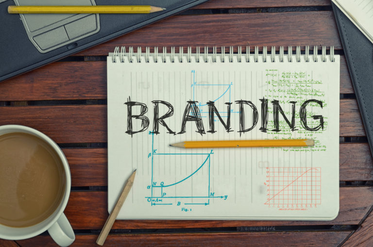 An open notebook with the word "Branding" written on the page.